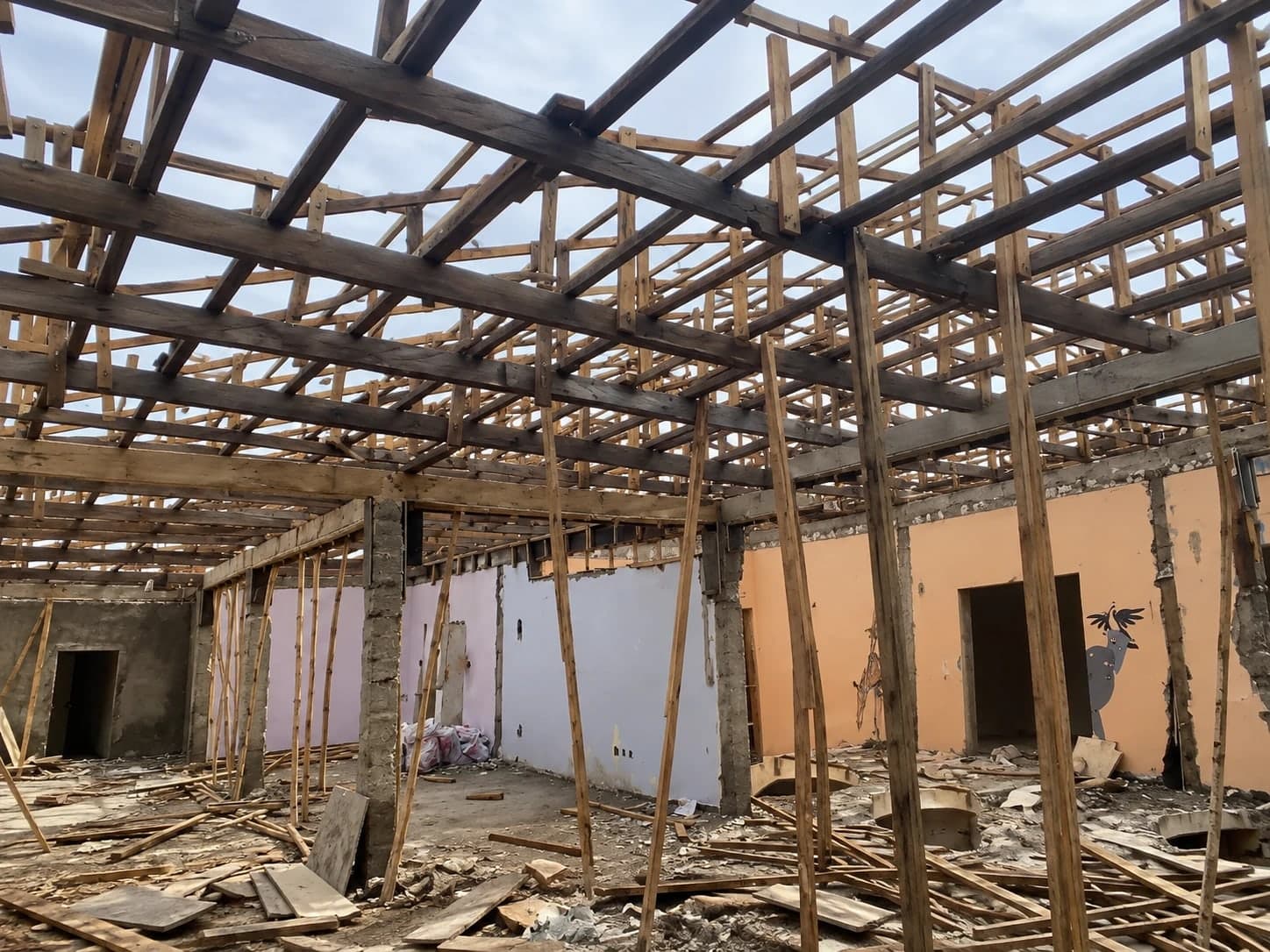 Inside The Vibe Abuja during the renovation, under the timber roof frame